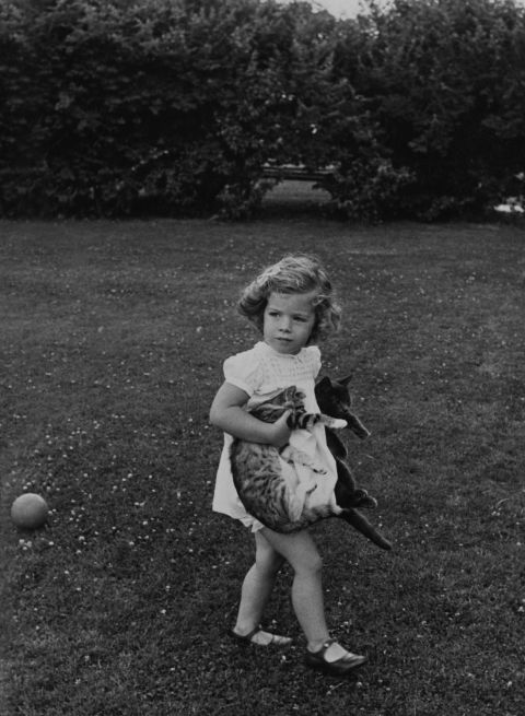 Caroline holds cats in the gardens of Hyannis Port in 1961.