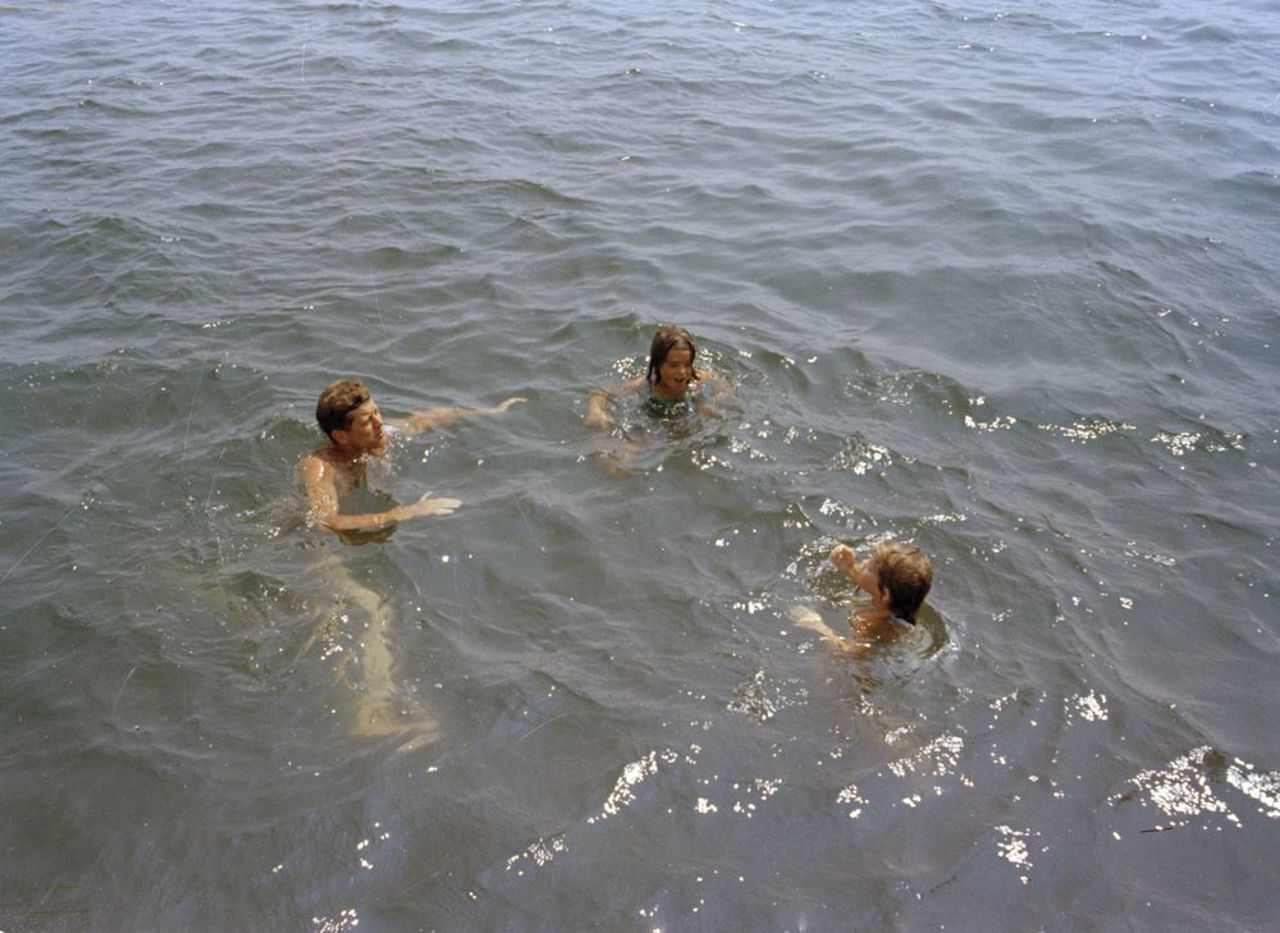 President Kennedy, left, swims with family and friends during a weekend in Hyannis Port in 1963.