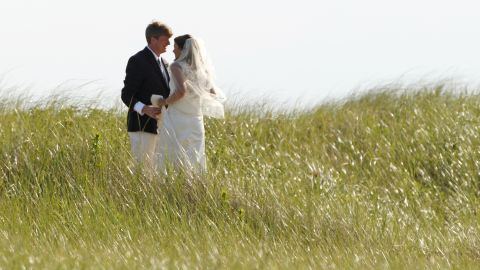 Former US Rep. Patrick Kennedy, one of Ted's sons, walks with his wife, Amy, after their wedding in Hyannis Port in 2011.