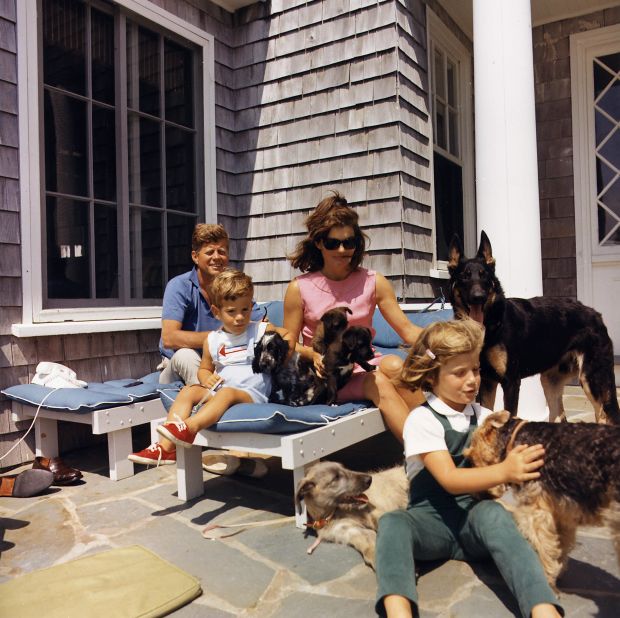 John and Jackie, joined by Caroline and John Jr., play with dogs in 1963.
