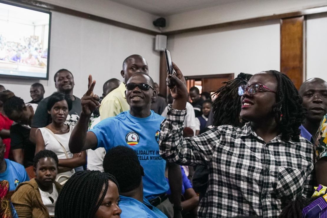 The overflowing courtroom sang Uganda's national anthem while they waited for the magistrate to arrive.