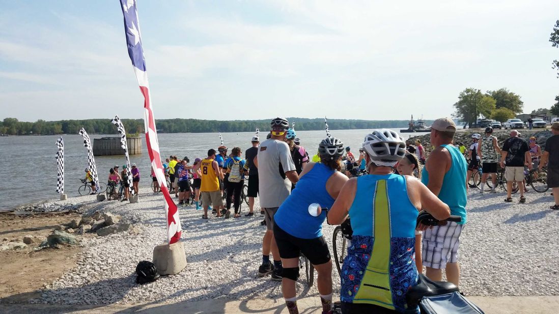 <strong>Journey's end: </strong>Exhausted and exuberant cyclists wait to dip their front tire in the Mississippi River after completing RAGBRAI 2019 in Keokuk, Iowa. The tradition symbolizes riders going "river to river" as the route starts west, near the Missouri River, and ends east, at the Mississippi River.