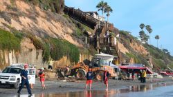 Search and rescue personnel work at the site of a cliff collapse at a popular beach Friday, Aug. 2, 2019, in Encinitas, Calif. At least one person was reportedly killed, and multiple people were injured, when an oceanfront bluff collapsed Friday at Grandview Beach in the Leucadia area of Encinitas, authorities said.(AP Photo/Denis Poroy)