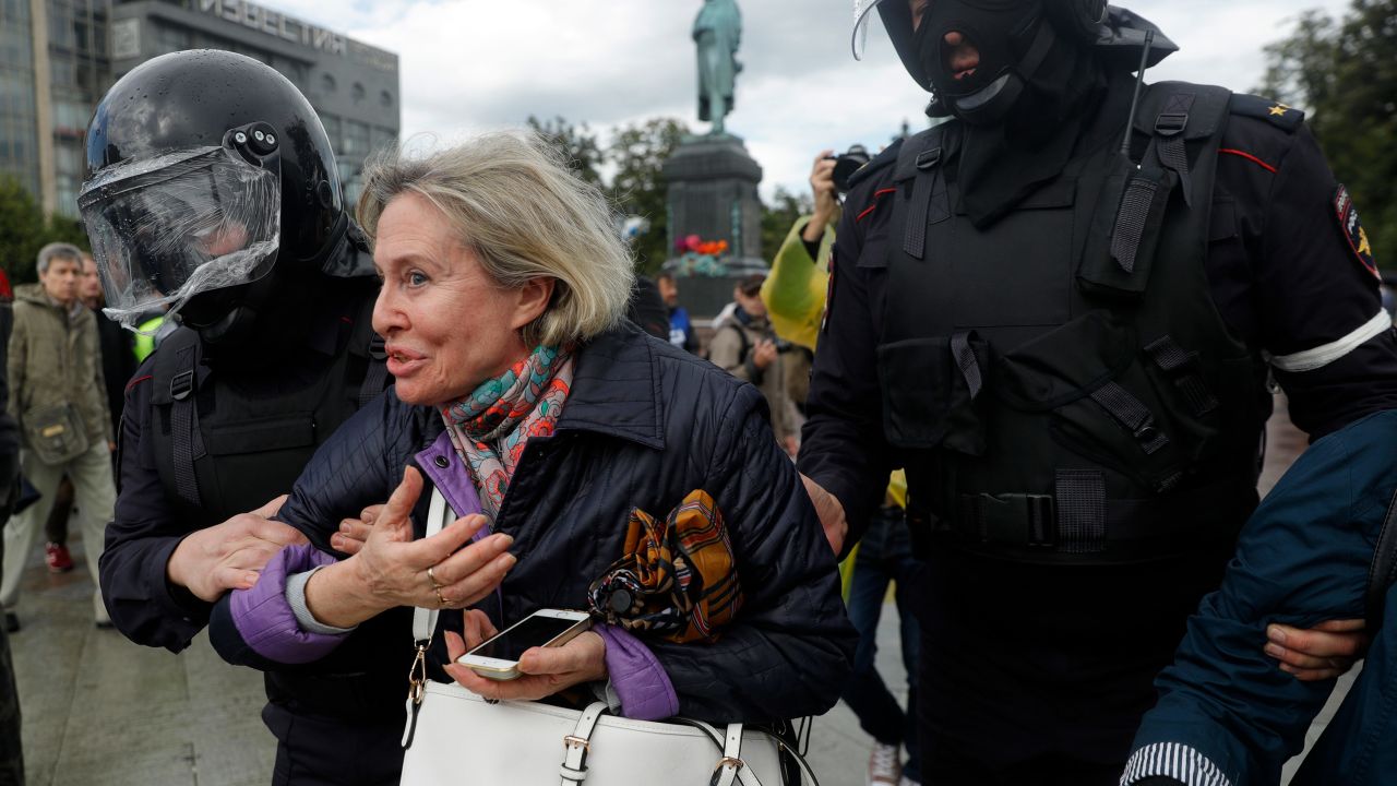Police officers detain a woman during an unsanctioned rally in central Moscow on Saturday. 
