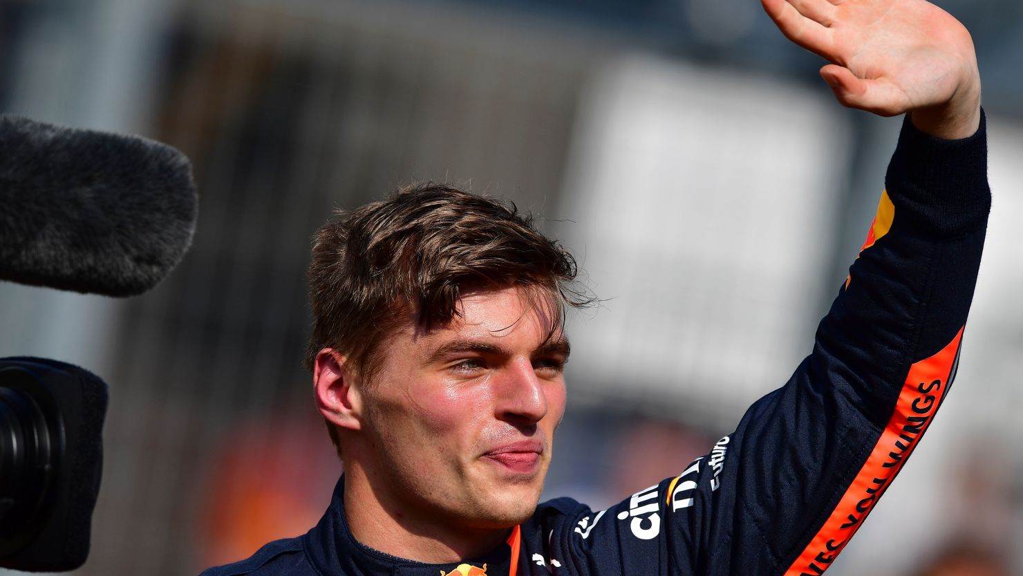 Max Verstappen waves to his traveling fans after securing the first pole position of his F1 career.