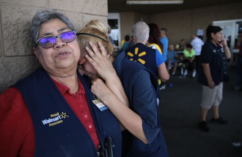 Walmart employees react Saturday after the shooting in El Paso.