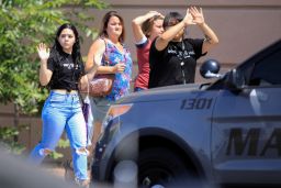 Shoppers exit with their hands up after Saturday's mass shooting at a Walmart in El Paso, Texas.