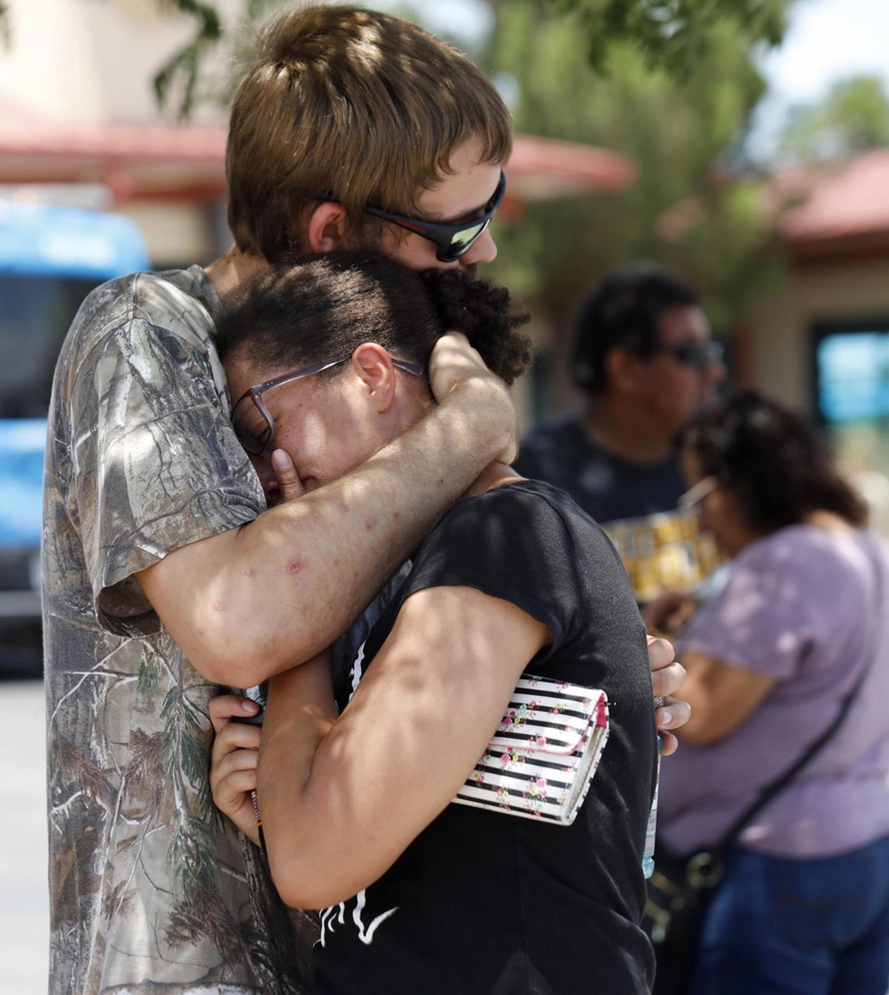 Kendall Long comforts Kianna Long, who was in the freezer section of the El Paso Walmart during the shooting.