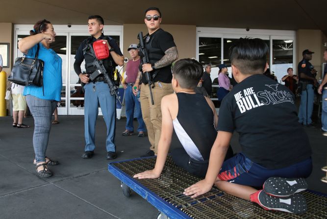 Police speak to witnesses at a nearby Sam's Club in El Paso.