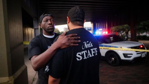 Witnesses comfort one another at the scene of a mass shooting in Dayton, Ohio.