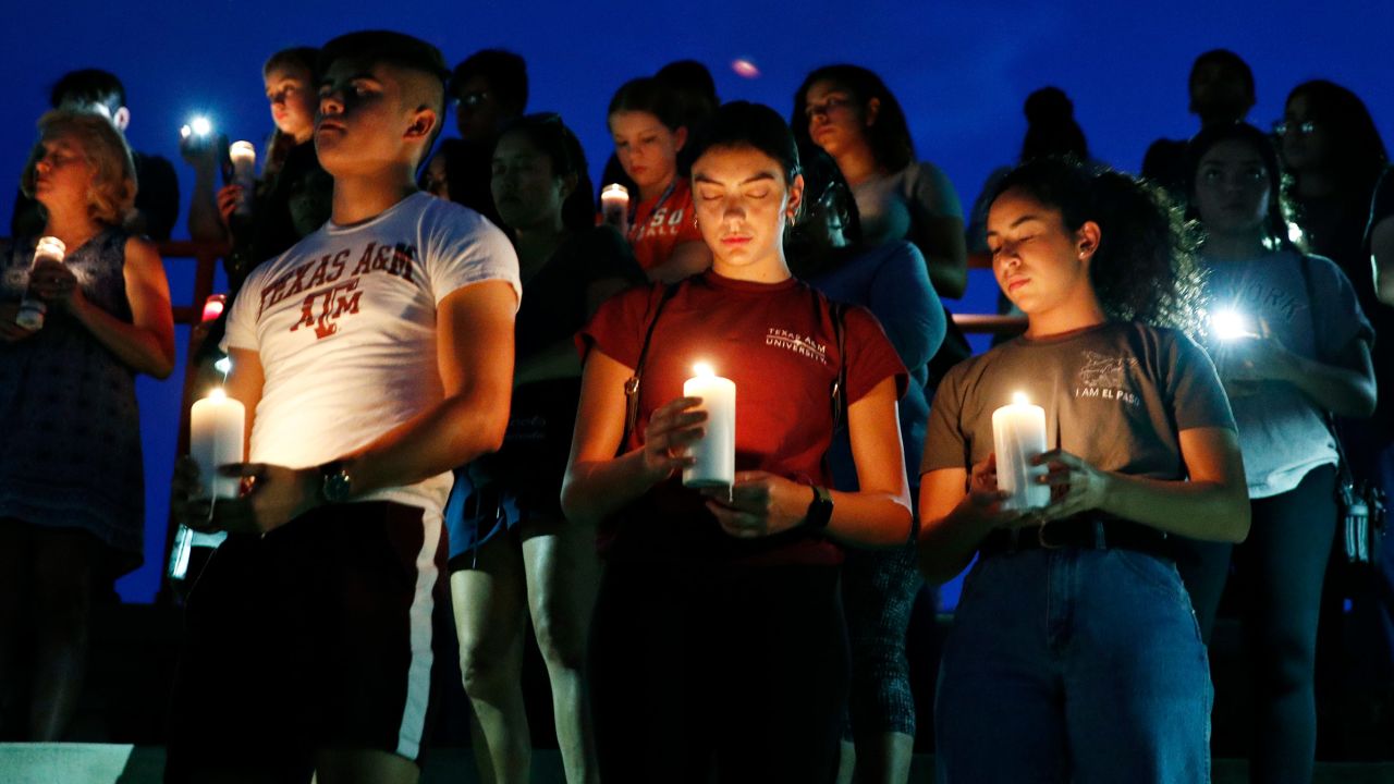 From left, Samuel Lerma, Arzetta Hodges and Desiree Quintanar attend a vigil in El Paso on Saturday.