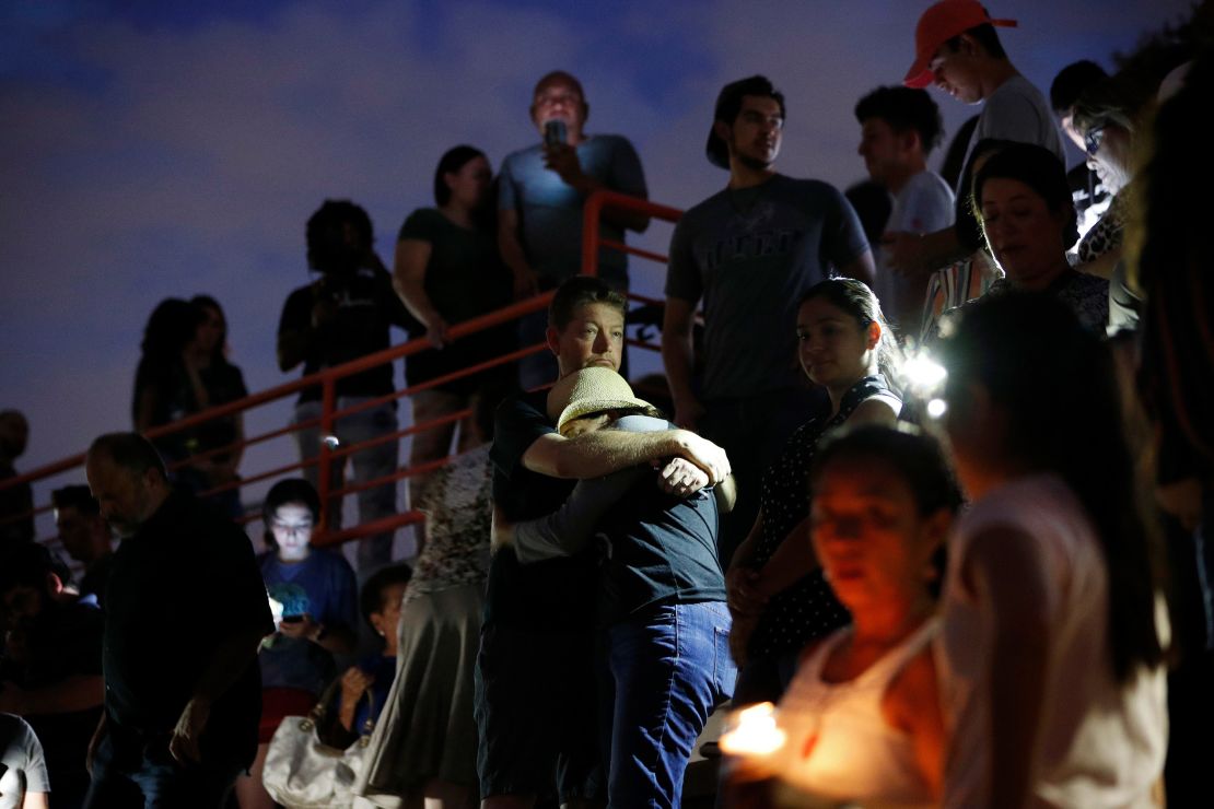 People embrace during a vigil for victims of the shooting Saturday, August 3, 2019, in El Paso, Texas. 