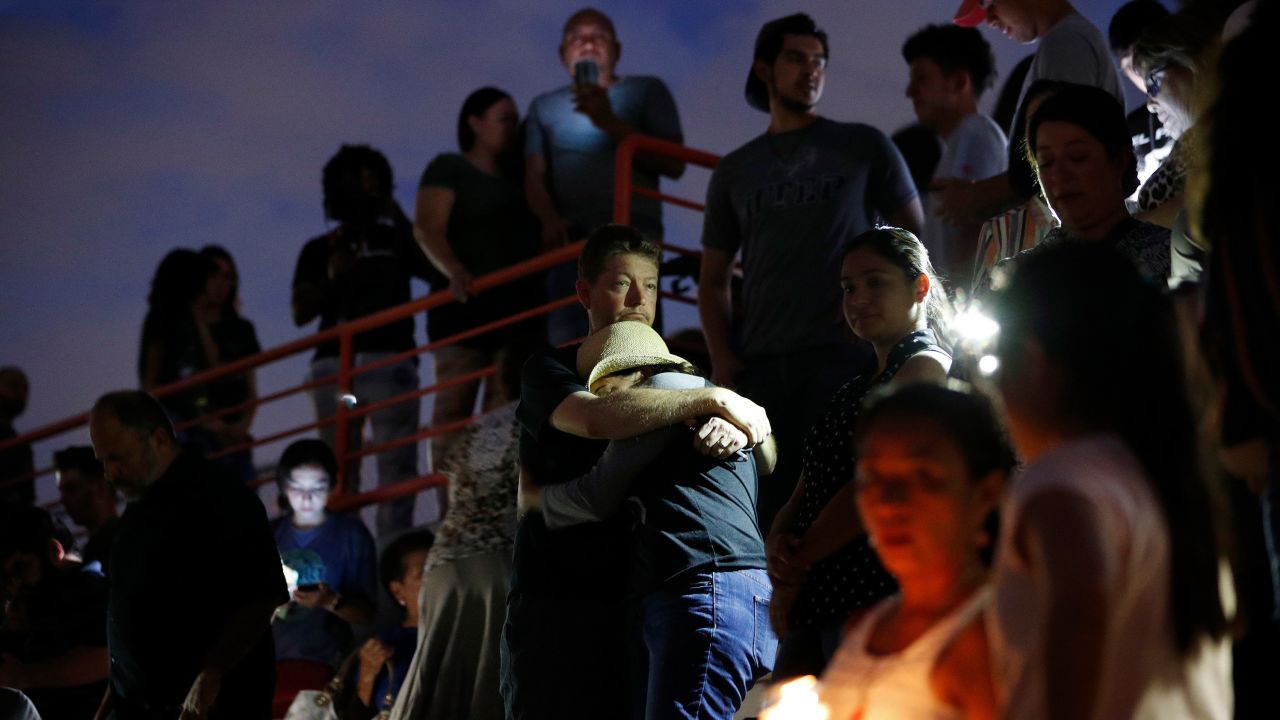 People embrace during a vigil for victims of the shooting Saturday, August 3, 2019, in El Paso, Texas.