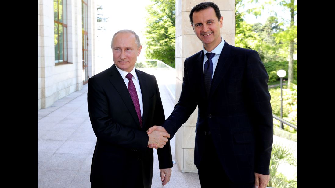 Putin shakes hands with Syrian President Bashar al-Assad during their meeting in Sochi in May 2018.