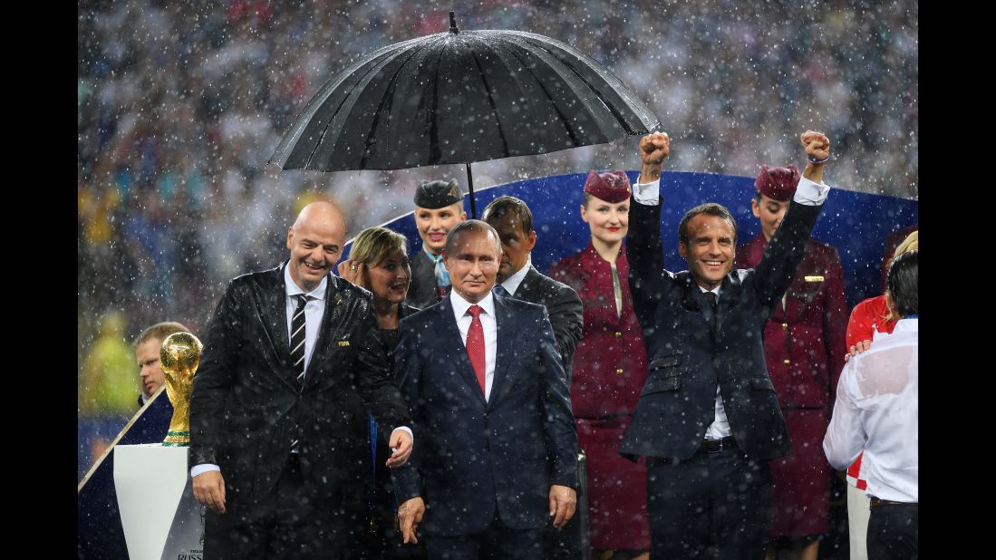 Putin stands with FIFA President Gianni Infantino, left, and French President Emmanuel Macron, right, after the 2018 World Cup final in Moscow. France defeated Croatia in the final.