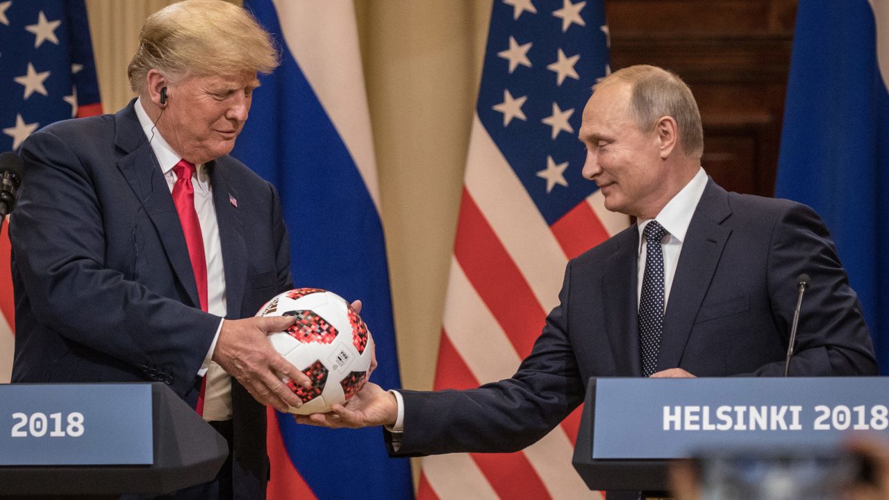 Putin hands Trump a World Cup soccer ball after their July 2018 summit in Helsinki, Finland.