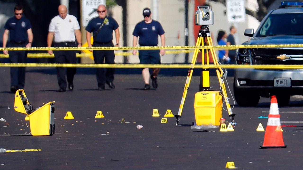 Evidence markers rest on the street at the scene of a mass shooting Sunday, Aug. 4, 2019, in Dayton, Ohio. Several people in Ohio have been killed in the second mass shooting in the U.S. in less than 24 hours, and the suspected shooter is also deceased, police said. (AP Photo/John Minchillo)