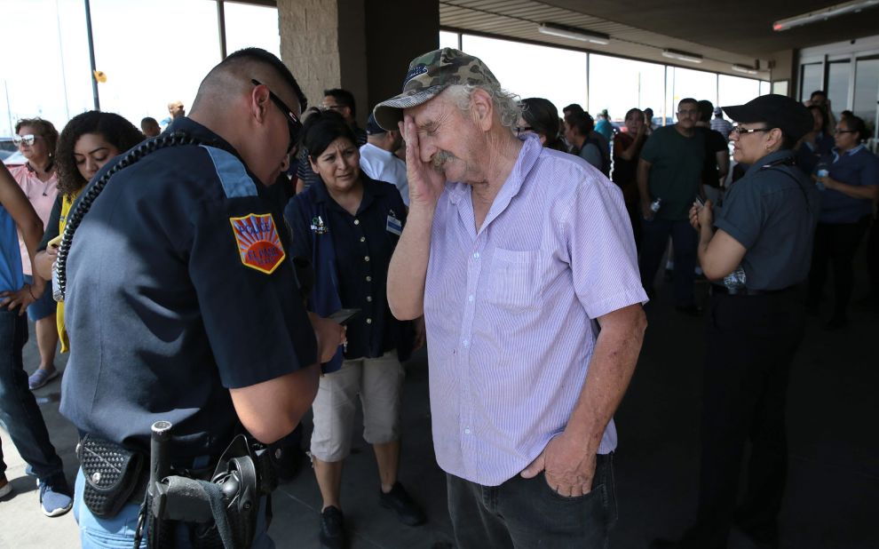 An El Paso police officer interviews a witness after the shooting.