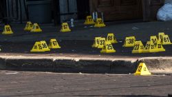 Police mark evidence after an active shooter opened fire in the Oregon district in Dayton, Ohio on August 4, 2019. - Nine people were killed in a mass shooting early Sunday in Dayton, Ohio, police said, adding that the assailant was shot dead by responding officers.The incident occurred shortly after 1:00 am in the popular bar and nightlife Oregon district of the city, Police Lieutenant Colonel Matt Carper said."We had one shooter that we are aware of and multiple victims," he told reporters."The shooter is deceased, from gunshot wounds from the responding officers," he said, adding no police were injured."We have nine victims deceased ... and we have approximately 16 more victims hospitalized right now in unknown conditions."The suspect had opened fire on the street firing "a long gun with multiple rounds." (Photo by Megan JELINGER / AFP)        (Photo credit should read MEGAN JELINGER/AFP/Getty Images)