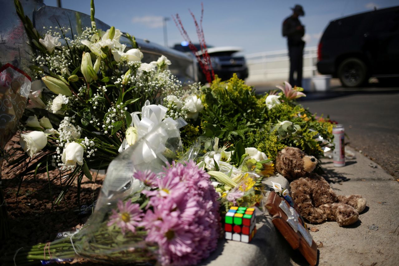 Flowers left by mourners lie near the site of the shooting in El Paso.