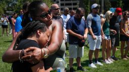 Mourners gather at a vigil following a nearby mass shooting, Sunday, Aug. 4, 2019, in Dayton, Ohio. Multiple people in Ohio have been killed in the second mass shooting in the U.S. in less than 24 hours, and the suspected shooter is also deceased, police said. (AP Photo/John Minchillo)