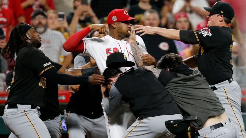 Cincinnati Reds relief pitcher Amir Garrett throws punches as he is held back by a number of Pittsburgh Pirates players as a bench clearing brawl breaks out in the ninth inning of the game between the Reds and the Pirates in Cincinnati on Tuesday, July 30. The Pirates won 11-4.