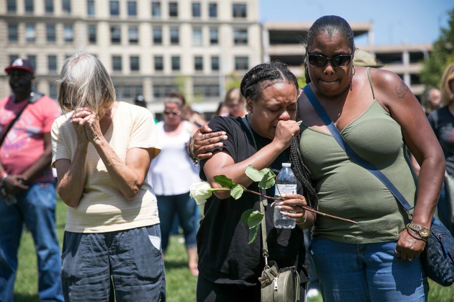 Mourners gather Sunday at a vigil in Dayton.