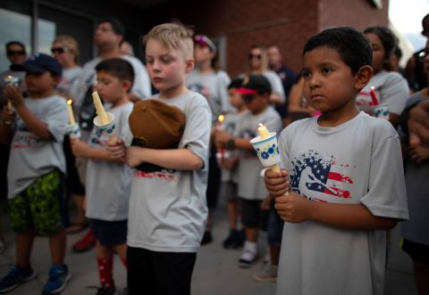 Children participate in an El Paso vigil Sunday.