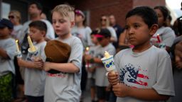 Children of a youth sports community participate in a vigil for the victims of Saturday's mass shooting in El Paso, Texas, Sunday, Aug. 4, 2019. 