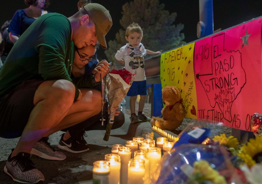 Mourners pray at a makeshift memorial for the victims of the El Paso shooting.