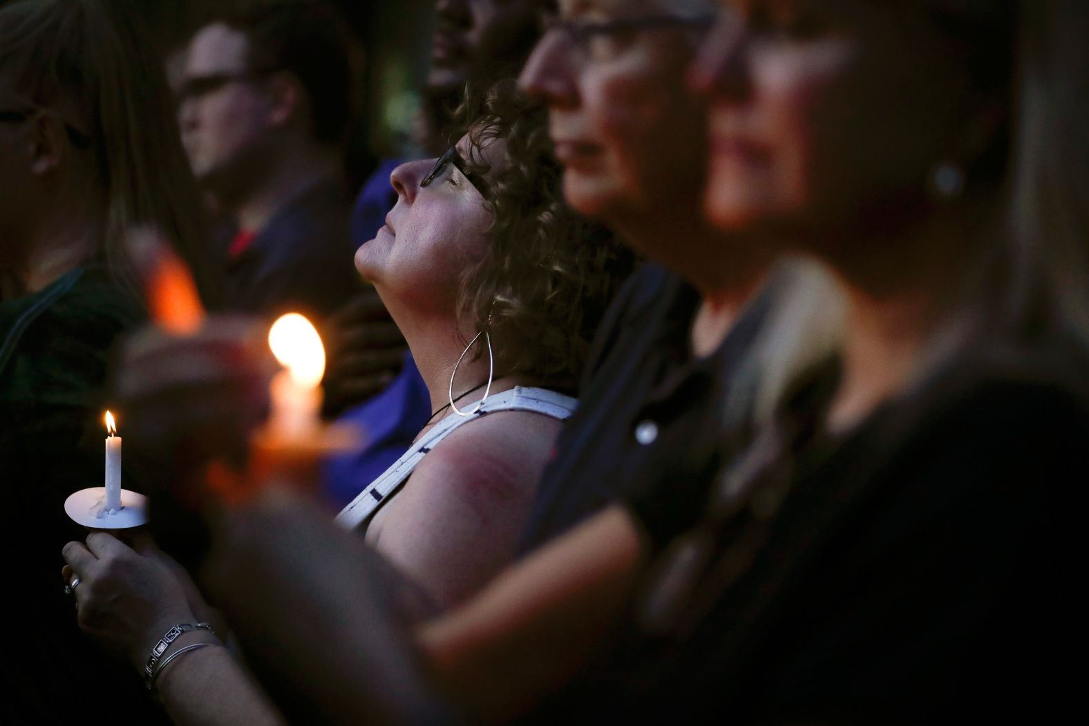 Mourners pause for a prayer in Dayton.