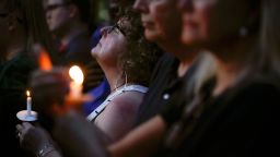 Mourners pause for a prayer as they gather for a vigil at the scene of a mass shooting, Sunday, August 4, 2019, in Dayton, Ohio. Multiple people in Ohio were killed in the second mass shooting in the U.S. in less than 24 hours.