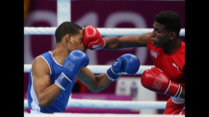Cuba's Andy Cruz and Hendri Cedeno Martinez compete during a Pan American Games boxing match in Lima, Peru, on Monday, July 29.