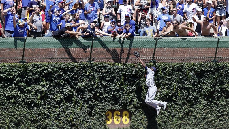 Lorenzo Cain of the Milwaukee Brewers is unable to catch the home run ball hit by Jason Heyward of the Chicago Cubs during the first inning of a game at Wrigley Field on Friday, August 2, in Chicago.