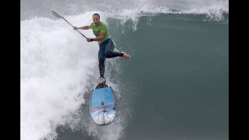 Candice Appleby of the United States rides a wave to win the silver medal in the surfing women's SUP race final during the Pan American Games in Lima, Peru, Friday, August 2.
