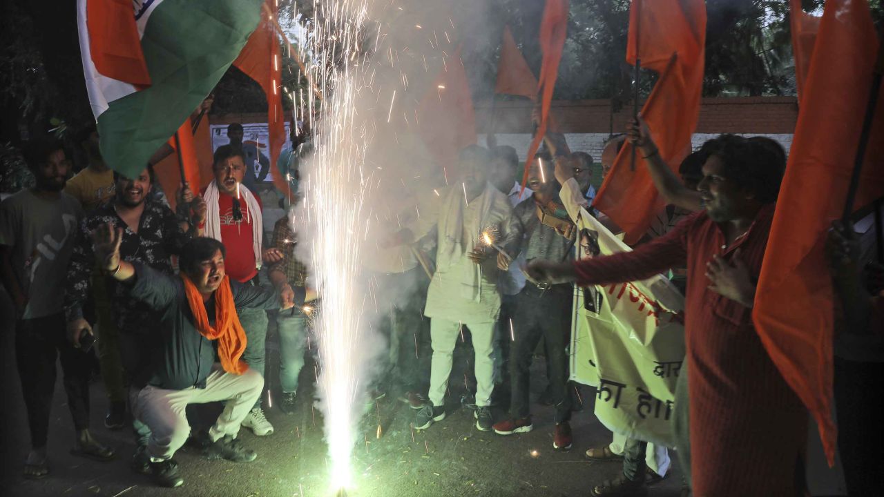Right wing Hindu groups light firecrackers as they celebrate the removal of Kashmir's special constitutional status in New Delhi. 