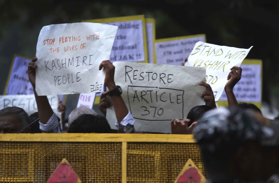 Left party supporters and students hold placards during a protest against the Indian government revoking Kashmir's special constitutional status in New Delhi, India on Monday. 