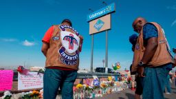 A chaplain (R) from a motorcycle group prays with friends at a makeshift memorial after the shooting that left 21 people dead at the Cielo Vista Mall WalMart in El Paso, Texas, on August 5, 2019. - US President Donald Trump on Monday urged Republicans and Democrats to agree on tighter gun control and suggested legislation could be linked to immigration reform after two shootings left 30 people dead and sparked accusations that his rhetoric was part of the problem. "Republicans and Democrats must come together and get strong background checks, perhaps marrying this legislation with desperately needed immigration reform," Trump tweeted as he prepared to address the nation on two weekend shootings in Texas and Ohio. "We must have something good, if not GREAT, come out of these two tragic events!" Trump wrote. (Photo by Mark RALSTON / AFP)        (Photo credit should read MARK RALSTON/AFP/Getty Images)