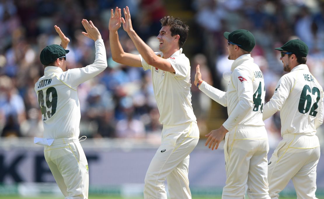 Australia bowler Pat Cummins (c) celebrates with team mates after bowling England batsman Jos Buttler.
