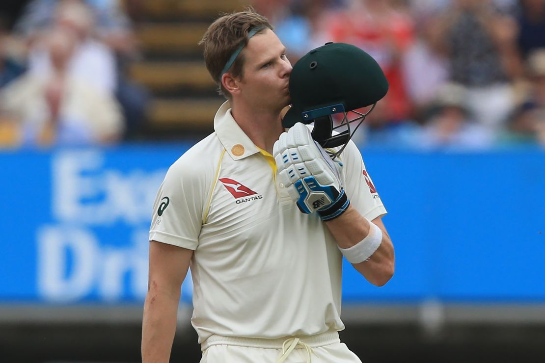 Steve Smith kisses his helmet as he celebrates reaching his century during play on the fourth day.