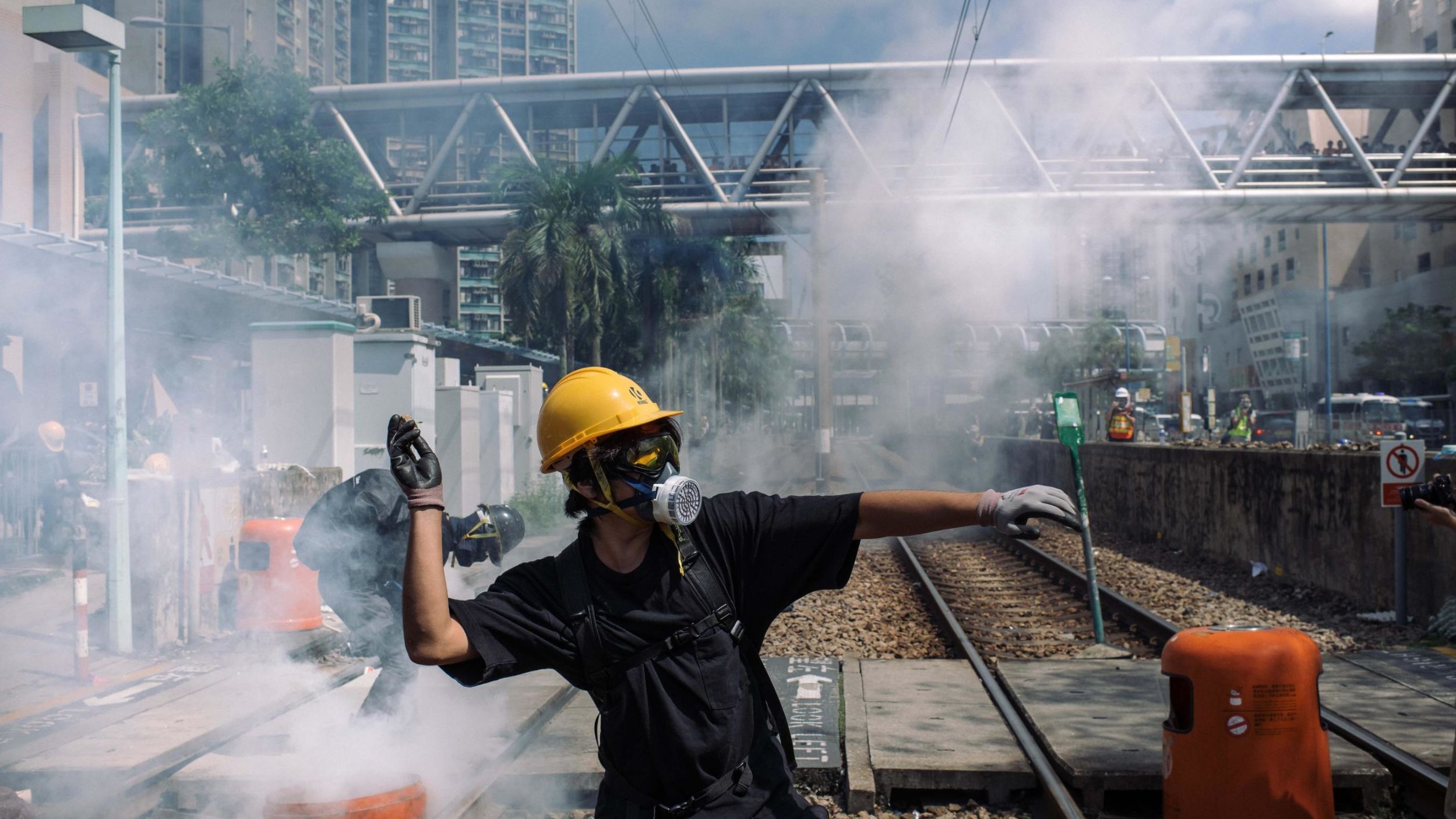  A protester throws a stone towards police outside Tin Shui Wai police station during a protest on August 5, 2019 in Hong Kong.