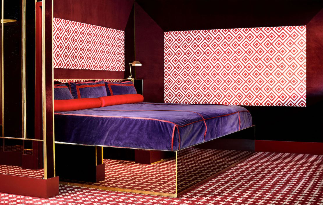 Cara's bedroom features an 11-foot-wide bed atop a mirrored platform.