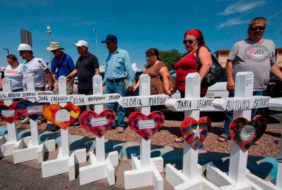 People pray Monday, August 5, at a makeshift memorial in El Paso.