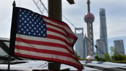 A US flag flies on a US consulate car with the backdrop of buildings in the Lujiazui financial district, outside a hotel where US trade negotiators are staying in Shanghai on July 31, 2019. - US and Chinese negotiators are holding talks aimed at resolve their year-long trade war after President Donald Trump warns China that getting a deal would be tougher if it waits for next year's US election. (Photo by GREG BAKER / AFP)        (Photo credit should read GREG BAKER/AFP/Getty Images)