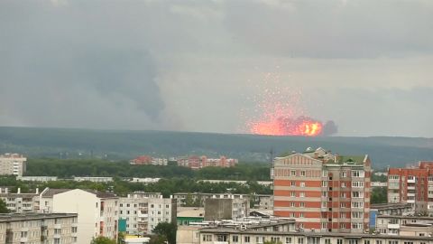 A fire at an arms depot in Siberia caused explosions and at least one death, according to Russian state media.