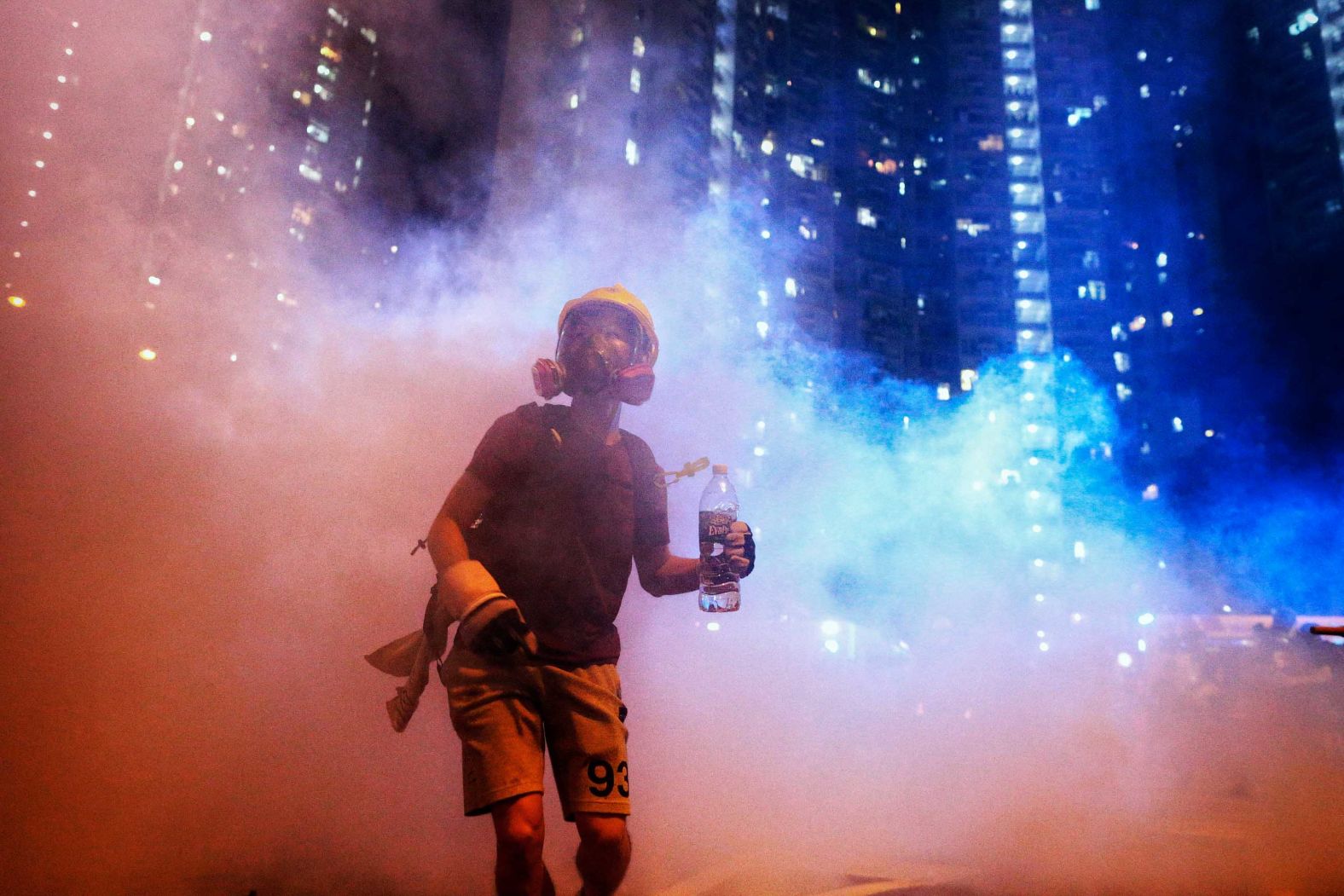 A protester stands in tear gas during a confrontation with police in the early hours of Sunday, August 4.