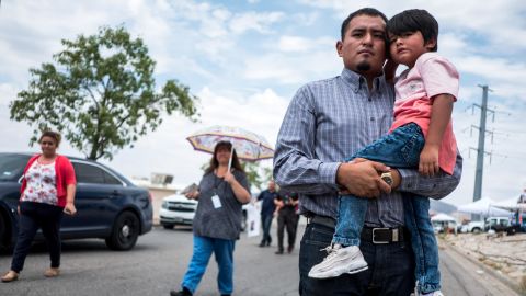 Ivan Flores, 27, poses with his son Derek, 4, near the site of the Walmart shooting in El Paso, Texas.