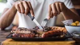 Man eating Grilled Meats; Shutterstock ID 1175573005; Job: -