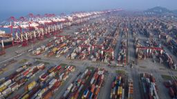 Gantry cranes and containers stand at the Yangshan Deepwater Port, operated by Shanghai International Port Group Co. (SIPG), in this aerial photograph taken in Shanghai, China, on Wednesday, Aug. 7, 2019. Trump's threat to raise tariffs on all Chinese goods last week shattered a truce reached with Xi just weeks earlier, unleashing tit-for-tat actions on trade and currency policy that risk accelerating a wider geopolitical fight between the world's biggest economies. Photographer: Qilai Shen/Bloomberg via Getty Images