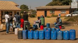 HARARE, ZIMBABWE - AUGUST 01: Members of the public queue for water at a borehole in Tafara on August 1, 2019 in Harare, Zimbabwe. Zimbabwe is facing an acute water shortage after this year's drought, compounded by poor water management. Rainfall is down 25 percent from the annual average, according to the Zimbabwean government, leaving two of Harare's four reservoirs empty. (Photo by Tafadzwa Ufumeli/Getty Images)